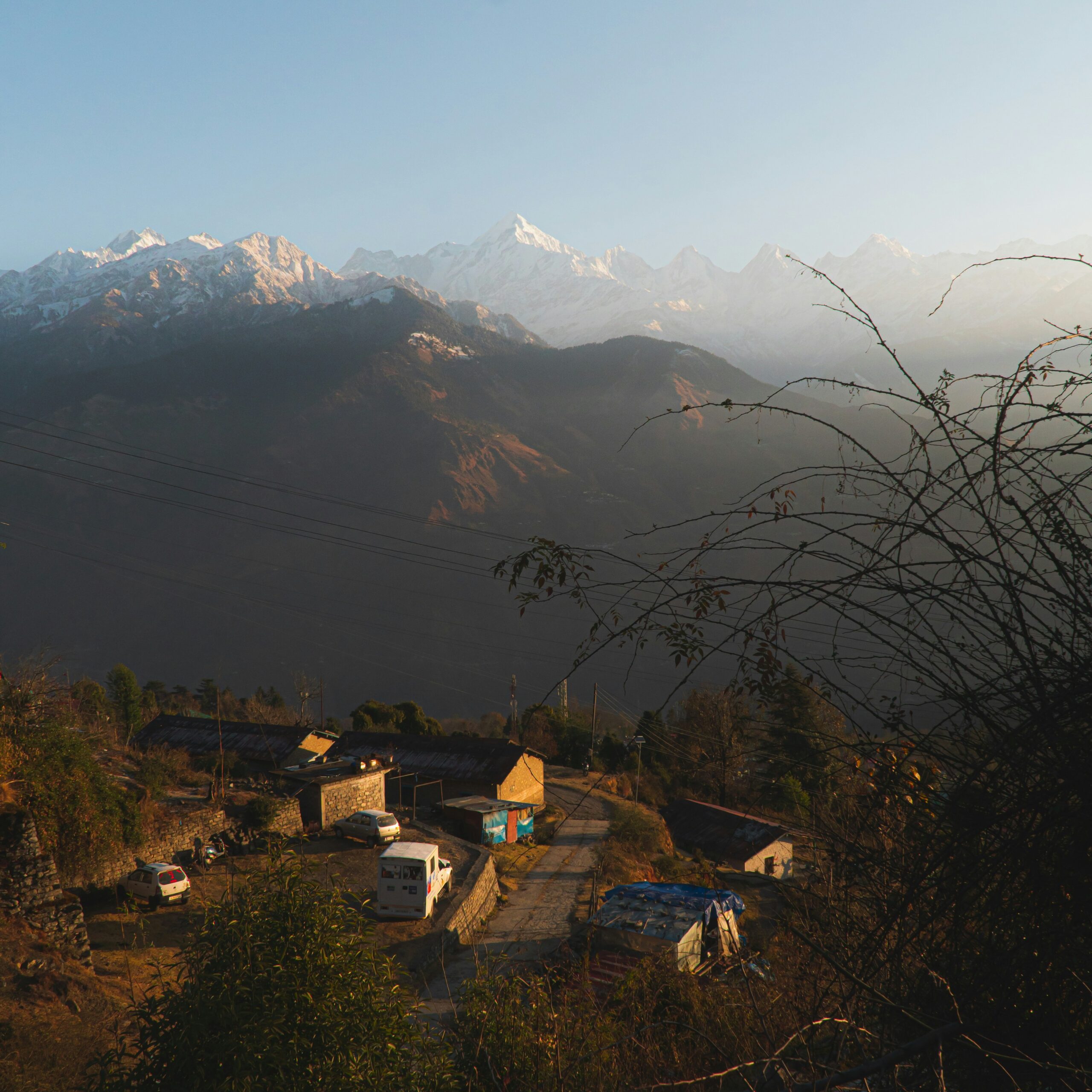 a view of a mountain range with a village in the foreground